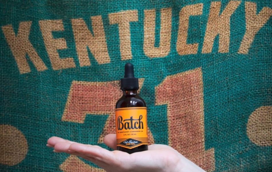 Kentucky's Pride: Hemp Seed Sack and Batch Full Spectrum CBD Oil Image of a hemp seed sack labeled 'Kentucky' alongside a bottle of Batch Full Spectrum CBD oil from Kentucky Cannabis Company.